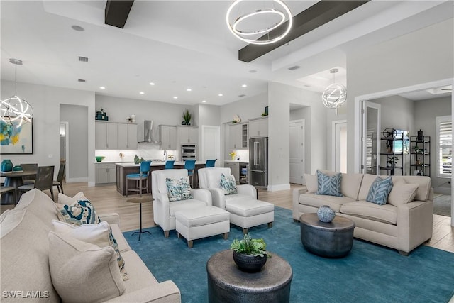 living room featuring hardwood / wood-style flooring and an inviting chandelier