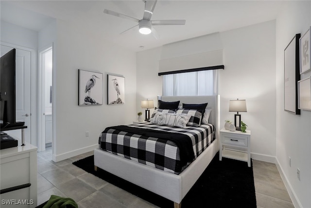 bedroom featuring light tile patterned floors, connected bathroom, and ceiling fan