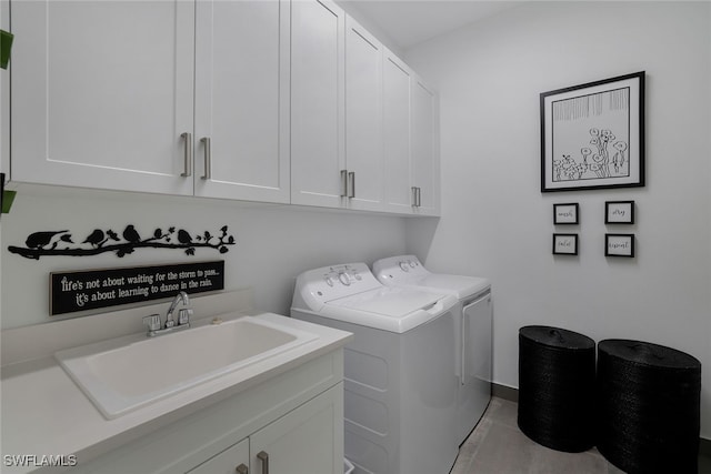 laundry room featuring sink, independent washer and dryer, and cabinets