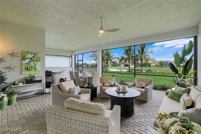 sunroom featuring ceiling fan