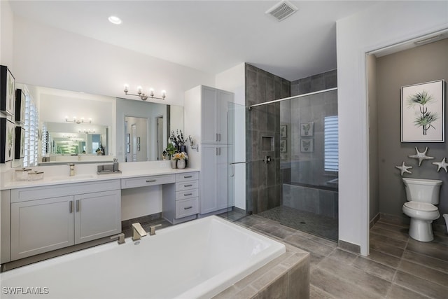 full bathroom featuring vanity, toilet, and separate shower and tub