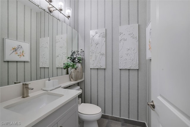 bathroom featuring vanity and toilet