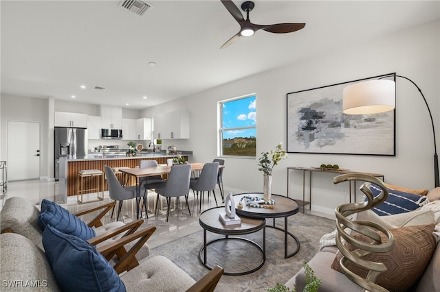 living room featuring sink and ceiling fan