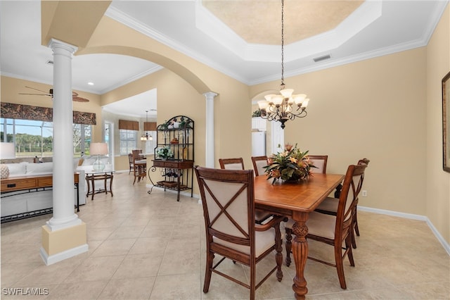 dining space with ornate columns, ceiling fan with notable chandelier, and crown molding