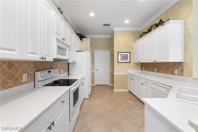 kitchen featuring backsplash, crown molding, white appliances, and white cabinetry