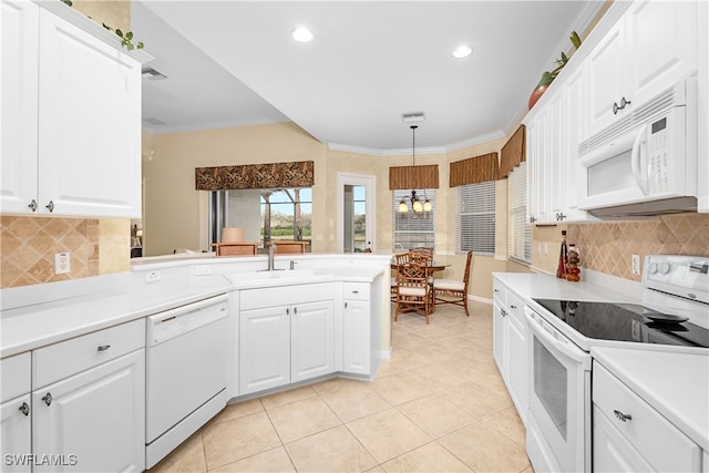 kitchen featuring sink, white appliances, decorative light fixtures, and white cabinets