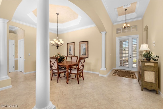 tiled entrance foyer featuring a notable chandelier, a raised ceiling, and crown molding