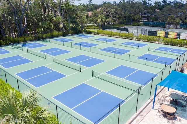 view of tennis court featuring basketball hoop