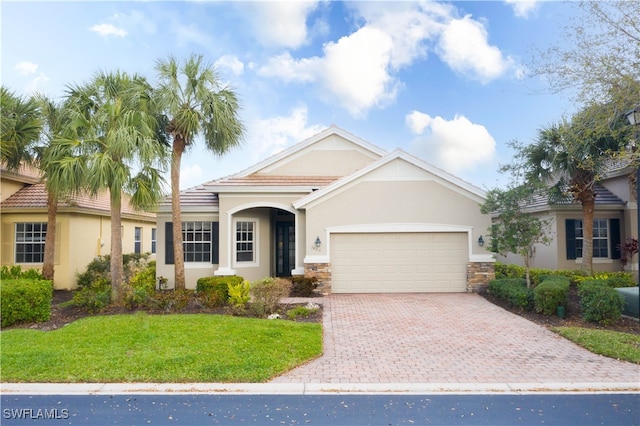 view of front of house featuring a front yard and a garage