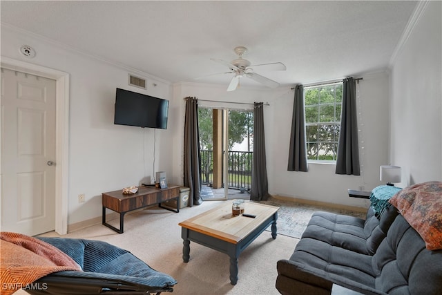 carpeted living room featuring ceiling fan, ornamental molding, and a textured ceiling