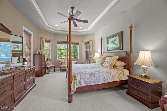 bedroom featuring ceiling fan, a raised ceiling, and light carpet