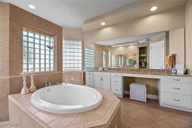 bathroom with a garden tub, recessed lighting, ceiling fan, vanity, and tile patterned floors