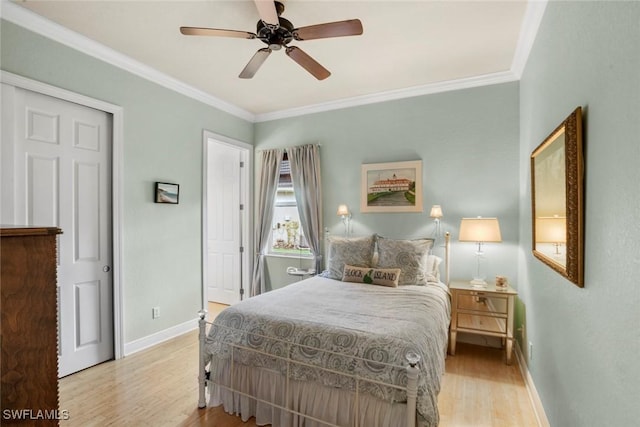 bedroom with ornamental molding, baseboards, ceiling fan, and light wood finished floors