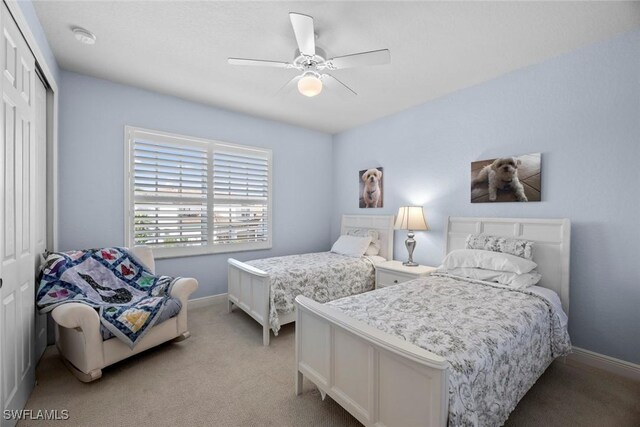 carpeted bedroom featuring a closet and ceiling fan