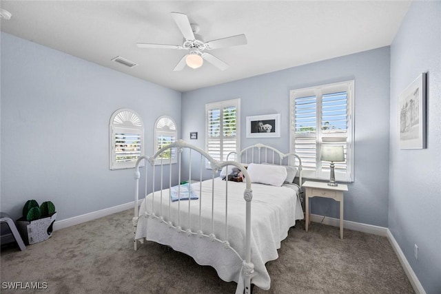 bedroom with carpet floors, visible vents, ceiling fan, and baseboards