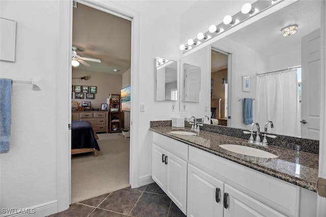 bathroom featuring tile patterned flooring, connected bathroom, ceiling fan, and a sink