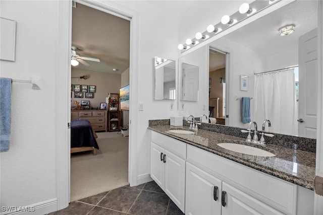ensuite bathroom with tile patterned flooring, ensuite bathroom, a sink, and ceiling fan
