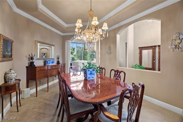 dining room with light tile patterned flooring, crown molding, a tray ceiling, and a chandelier