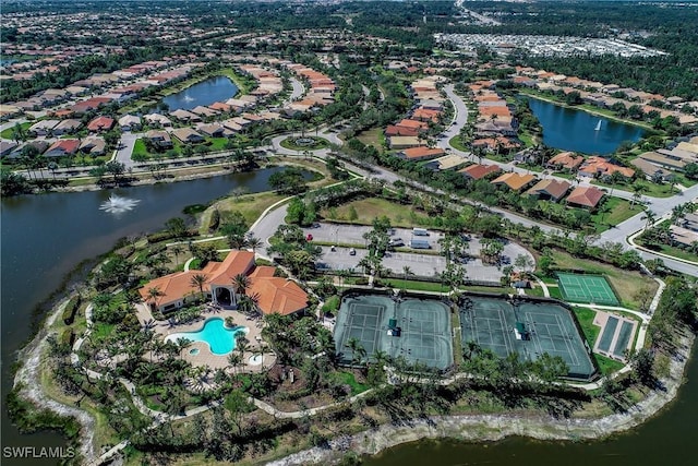 birds eye view of property with a water view and a residential view