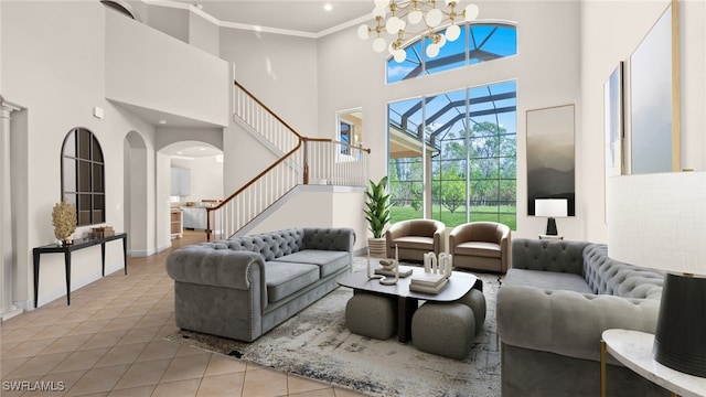 tiled living room featuring ornamental molding, a notable chandelier, and a towering ceiling