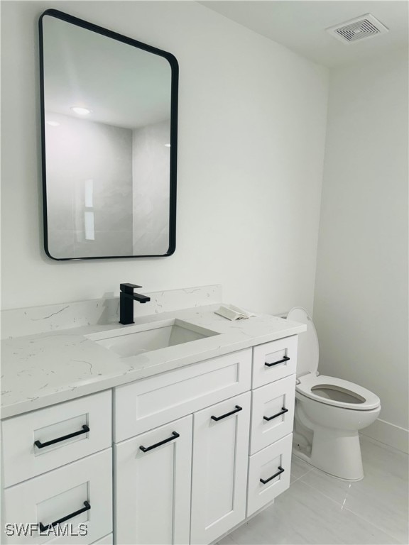 bathroom with toilet and vanity