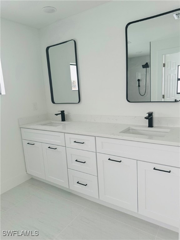 bathroom featuring vanity, a shower, and tile patterned flooring