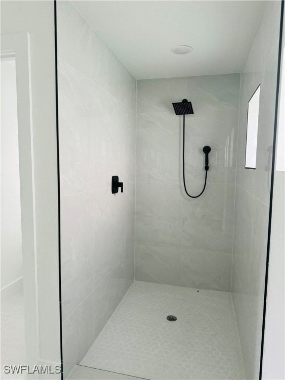 bathroom featuring tile patterned floors and tiled shower