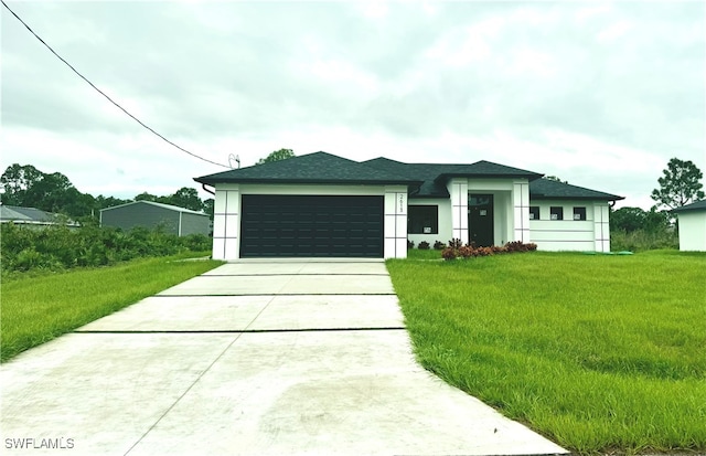 view of front of home with a garage and a front lawn