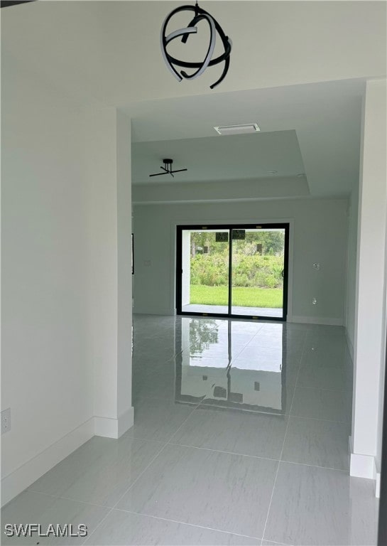 empty room featuring ceiling fan and light tile patterned floors