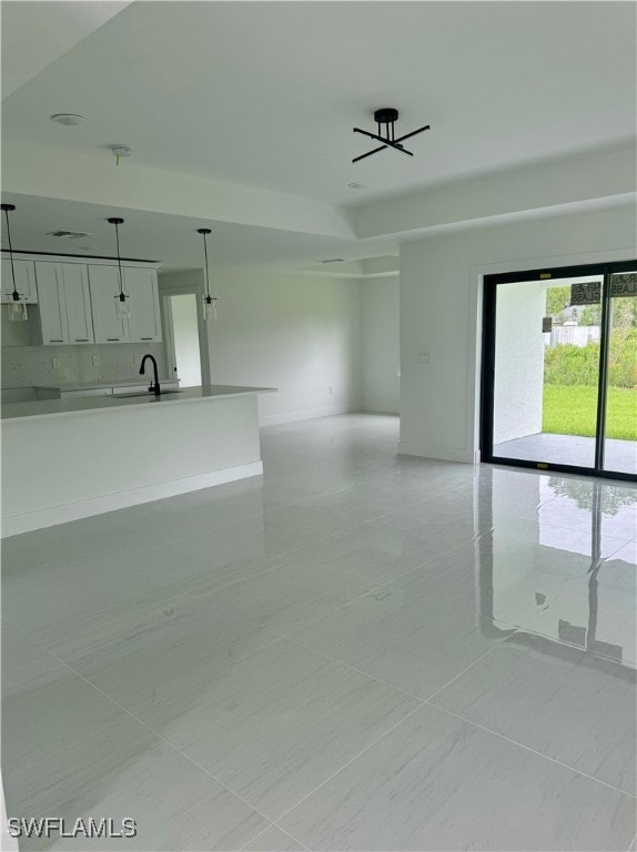 tiled empty room featuring sink