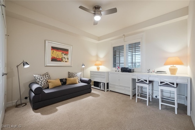 sitting room with ceiling fan and carpet flooring