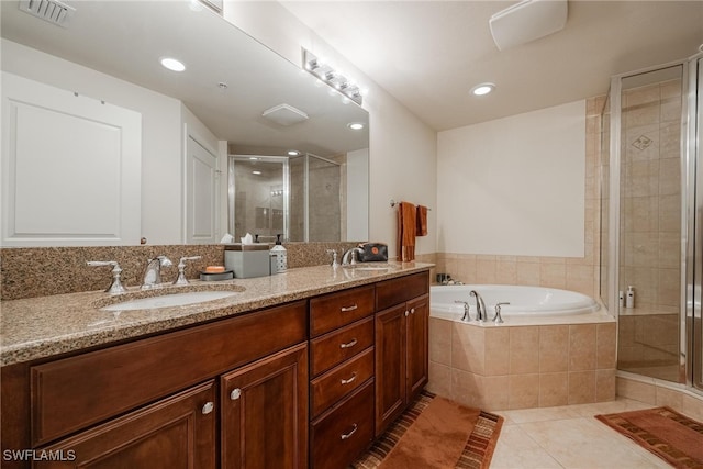 bathroom featuring shower with separate bathtub, tile patterned floors, and vanity