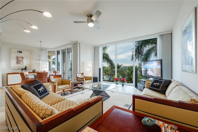 living room featuring expansive windows and ceiling fan