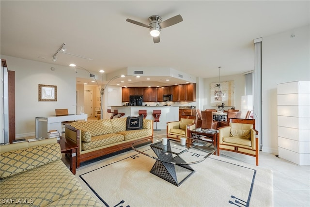 tiled living room with track lighting and ceiling fan