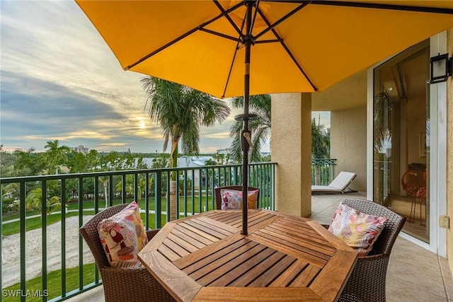 3426 Hancock Bridge Pkwy Unit 407, North Fort Myers, FL 33903 - balcony at dusk with outdoor dining space