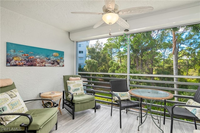 sunroom featuring ceiling fan