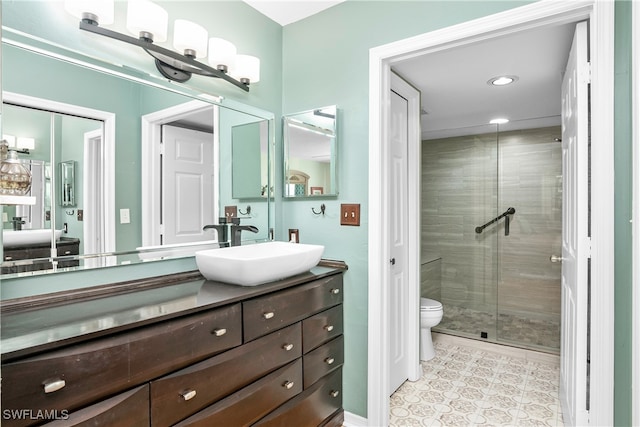 bathroom featuring vanity, toilet, and an enclosed shower