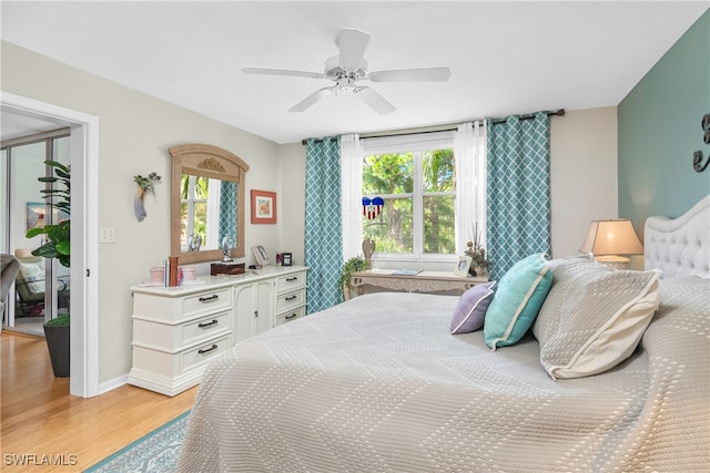 bedroom with ceiling fan, multiple windows, and light wood-type flooring