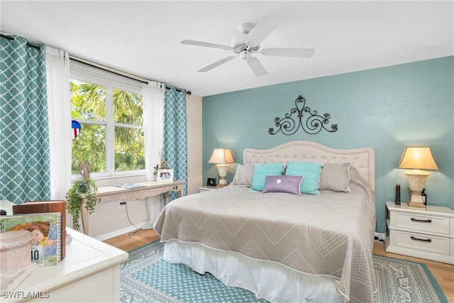 bedroom with ceiling fan and light wood-type flooring