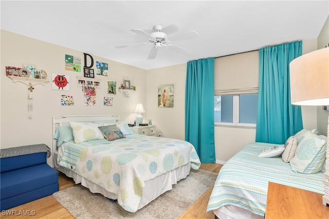 bedroom featuring light wood-type flooring and ceiling fan