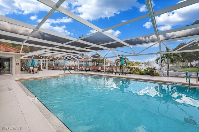 view of swimming pool with a lanai and a patio area