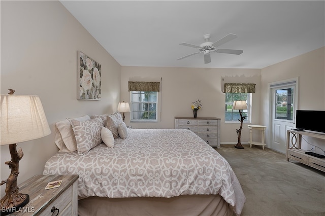 bedroom featuring light carpet, multiple windows, and ceiling fan