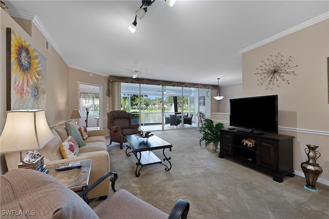 living room featuring crown molding, ceiling fan, a healthy amount of sunlight, and light carpet