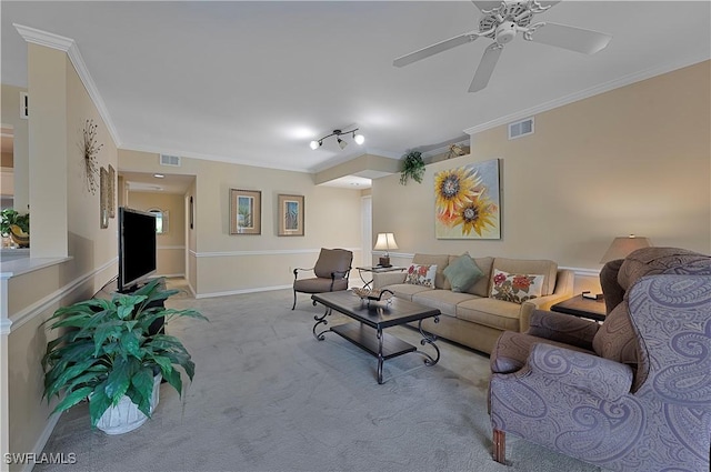 carpeted living room with ceiling fan and ornamental molding