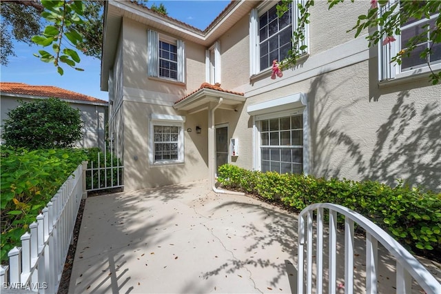 entrance to property featuring a patio area