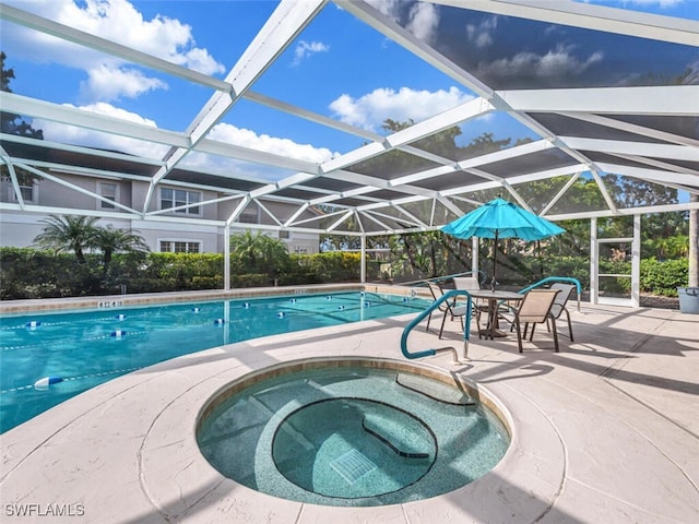 view of swimming pool featuring an in ground hot tub, a lanai, and a patio