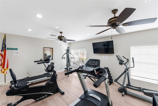 workout room featuring ceiling fan and light hardwood / wood-style floors