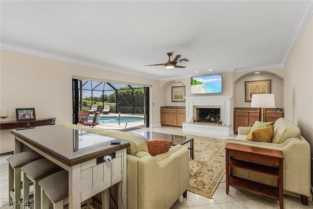 living room with crown molding, ceiling fan, and light tile patterned floors