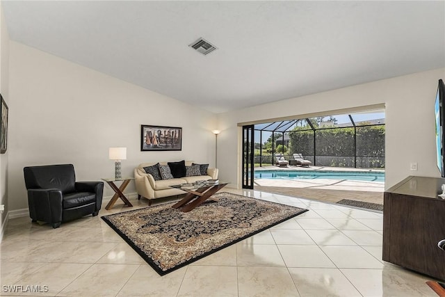 living room with lofted ceiling and light tile patterned floors