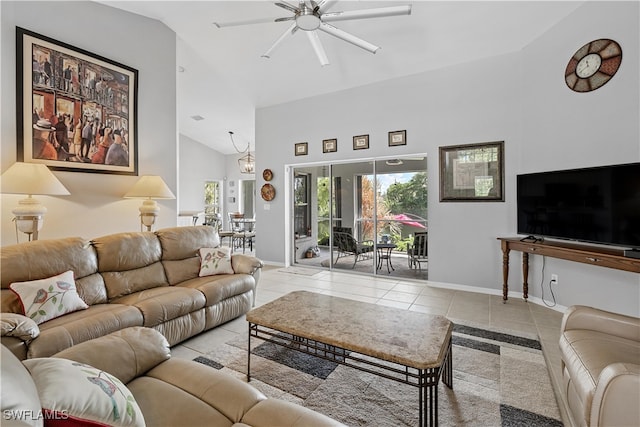 tiled living room with ceiling fan and high vaulted ceiling